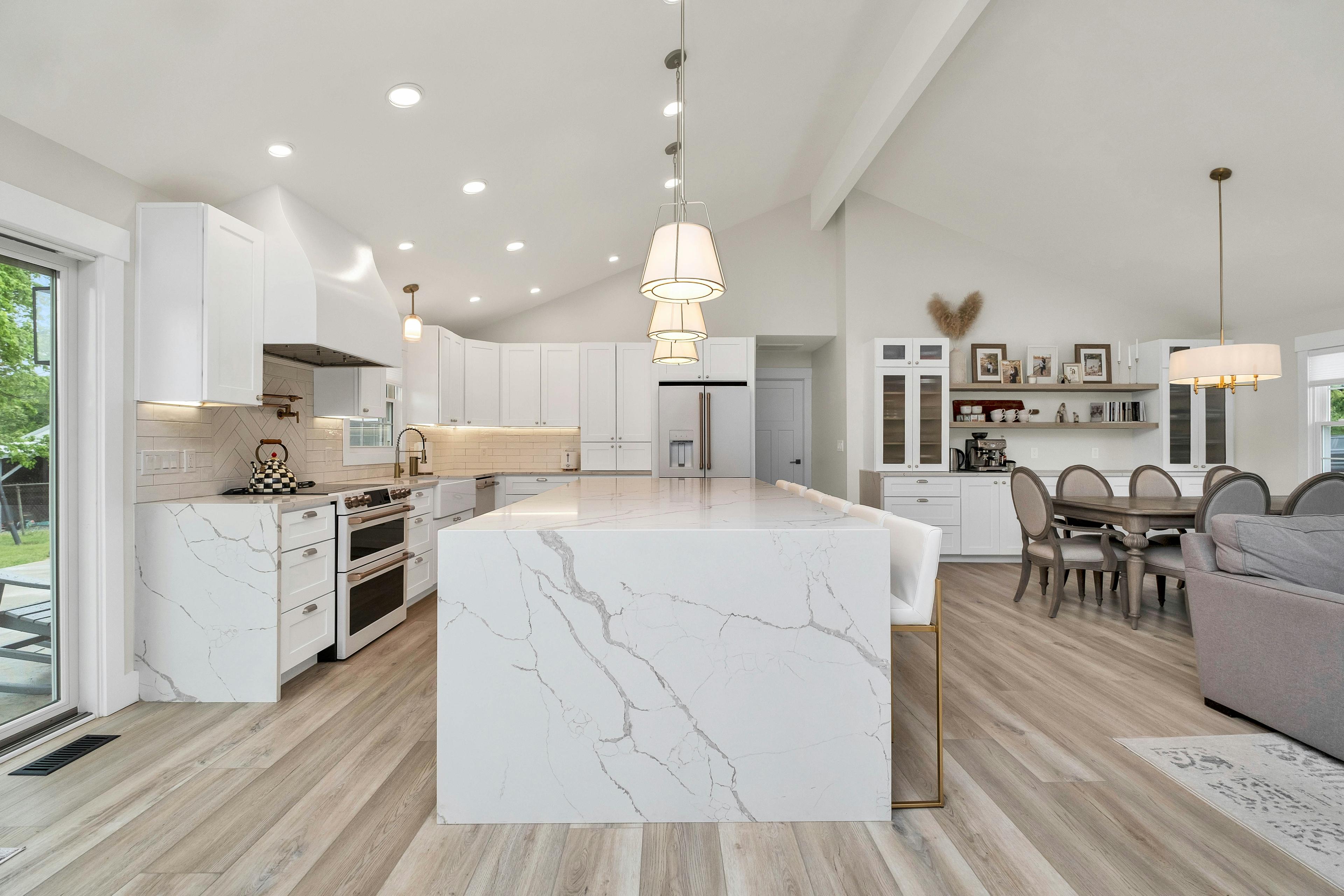 Modern kitchen renovation with custom island cabinetry and finish lighting